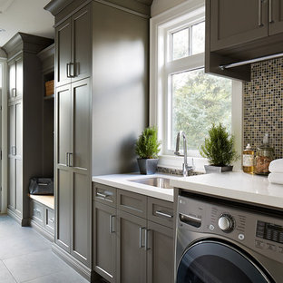 Inspiration for a traditional single-wall utility room in Toronto with a submerged sink, shaker cabinets, brown cabinets, a side by side washer and dryer and grey walls.