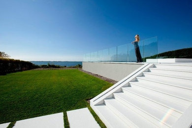 Inspiration for a modern white three-story stucco exterior home remodel in New York