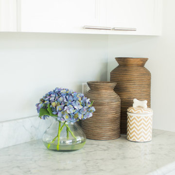 White Kitchen with Gray Marble Counters and Brown Kitchen Table