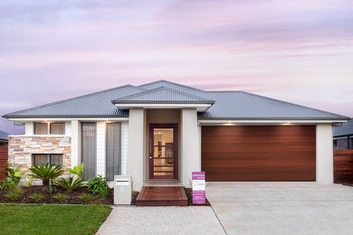 Design ideas for a beach style one-storey beige house exterior in Brisbane with mixed siding and a metal roof.