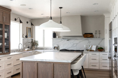 Example of a large classic eat-in kitchen design in Portland with shaker cabinets, white cabinets, quartzite countertops, white backsplash, stainless steel appliances and an island