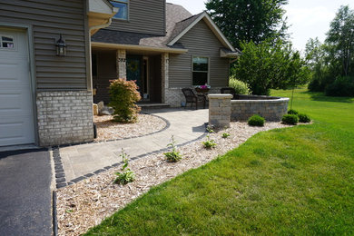 Photo of a small traditional front yard patio in Other with concrete pavers and no cover.