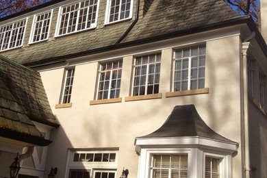 Inspiration for a large craftsman beige two-story stucco exterior home remodel in Detroit