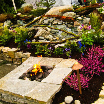 Gas fire pit next to waterfall