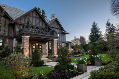 Mid-sized traditional gray two-story brick exterior home idea in Vancouver with a shingle roof
