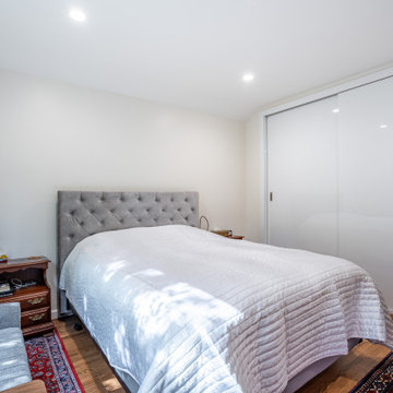 Primary Bedroom with Sliding Closet Doors and Refinished Hardwood Floors – Kerri