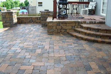 This is an example of a mid-sized traditional backyard patio in San Francisco with brick pavers and no cover.