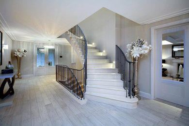 Photo of a large contemporary hallway in London with beige walls and porcelain floors.