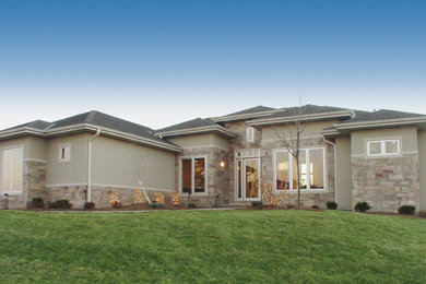 Inspiration for a large contemporary gray one-story stone exterior home remodel in Other with a hip roof