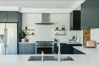 This is an example of a modern kitchen in Napier-Hastings with solid surface benchtops, white splashback, porcelain splashback and white benchtop.