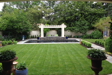 Inspiration for a large traditional backyard partial sun garden in Philadelphia with natural stone pavers.