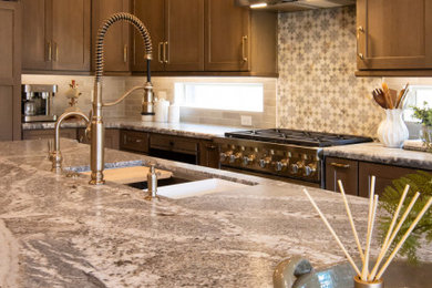 Large elegant porcelain tile and beige floor open concept kitchen photo in Phoenix with an undermount sink, shaker cabinets, medium tone wood cabinets, granite countertops, paneled appliances and an island