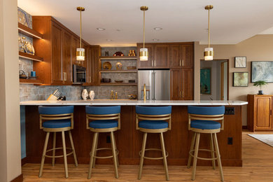 Inspiration for a large contemporary u-shaped vinyl floor and brown floor open concept kitchen remodel in Other with an undermount sink, recessed-panel cabinets, medium tone wood cabinets, quartz countertops, blue backsplash, porcelain backsplash, stainless steel appliances, a peninsula and multicolored countertops