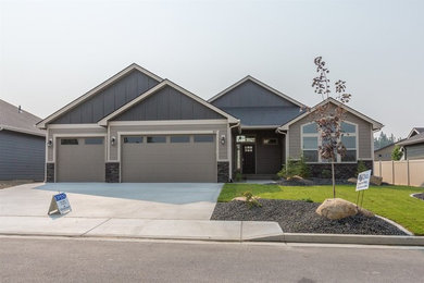 Example of a classic gray one-story mixed siding house exterior design in Other with a gambrel roof and a shingle roof