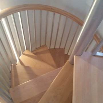 Spiral stairs with wood maple treads and handrail.