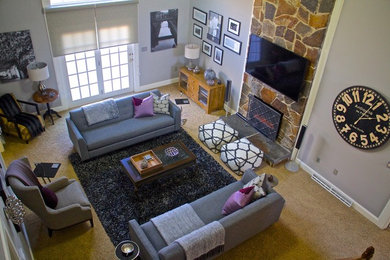 Example of a large transitional open concept carpeted and beige floor living room design in Boston with gray walls, a standard fireplace, a stone fireplace and a wall-mounted tv