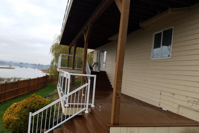 Large minimalist backyard deck photo in Seattle with no cover