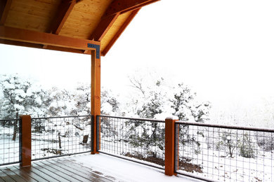 This is an example of a large modern back porch design in Denver.