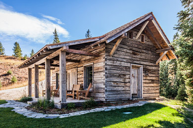 Example of a mid-sized mountain style brown one-story wood gable roof design in Other