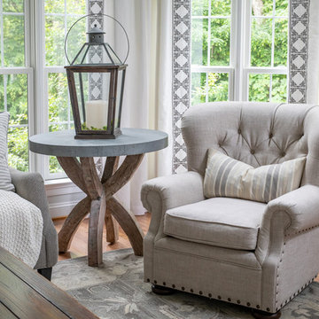 Neutral Two Story Family Room with Tufted Wing Chairs