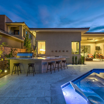 Contemporary Backyard Pool with Tiled Water Feature, Rim Flow Spa, & Fire Pit