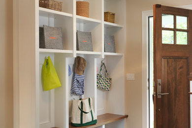 Entryway - farmhouse medium tone wood floor entryway idea in Providence with beige walls and a medium wood front door