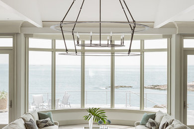 Example of a large beach style open concept dark wood floor living room design in Boston with white walls, a standard fireplace and no tv