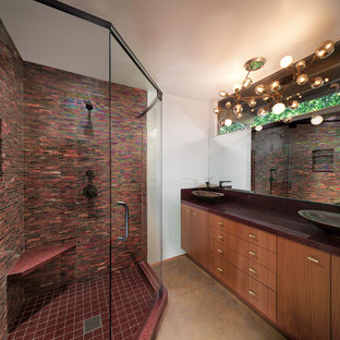 Mid-sized 1960s master red tile and glass tile concrete floor corner shower photo in Los Angeles with flat-panel cabinets, medium tone wood cabinets, a two-piece toilet, white walls and a vessel sink