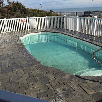 Pool with permeable paver surround