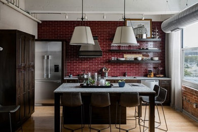 Inspiration for a mid-sized transitional galley light wood floor and yellow floor eat-in kitchen remodel in Other with an undermount sink, shaker cabinets, dark wood cabinets, granite countertops, red backsplash, porcelain backsplash, stainless steel appliances, an island and gray countertops