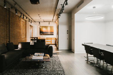 Mid-sized minimalist loft-style living room photo in New York with white walls