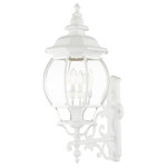 Livex Lighting - Textured White Traditional, Colonial, French Historical, Outdoor Wall Lantern - The classically transitional outdoor Frontenac collection boasts a cast aluminum structure with dazzling ornamental design.  The upward facing four-light large six-sided wall lantern comes in a textured white finish with clear beveled glass and extravagantly decorative scrolls. The ornate quality of this light will add radiance to your house exterior day or night.