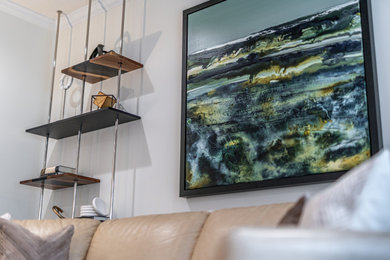 Inspiration for a contemporary laminate floor and gray floor living room remodel in Toronto with white walls, a standard fireplace and a stone fireplace