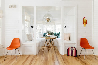 Small beach style light wood floor and brown floor breakfast nook photo in Other with white walls and no fireplace