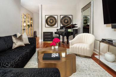 На фото: открытая гостиная комната среднего размера в стиле модернизм с музыкальной комнатой, серыми стенами, паркетным полом среднего тона, телевизором на стене и сводчатым потолком