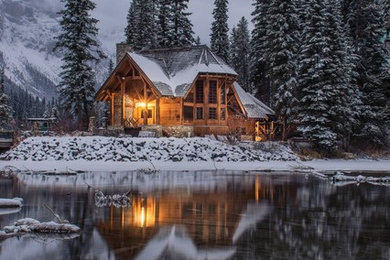 Inspiration for a mid-sized rustic brown two-story wood house exterior remodel in Seattle with a hip roof and a shingle roof