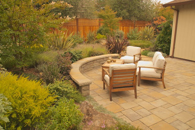 Example of a mid-sized classic backyard stone patio design in San Francisco with no cover