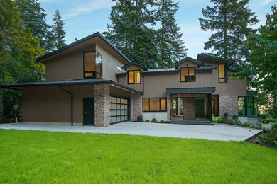 Photo of a large contemporary front yard driveway in Vancouver.