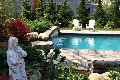Example of a mid-sized transitional side yard concrete paver and rectangular pool fountain design in Providence