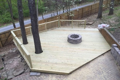 Mid-sized elegant backyard deck photo in Other with a fire pit and no cover