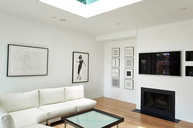 Living room - mid-sized modern enclosed light wood floor and beige floor living room idea in Seattle with white walls, a standard fireplace, a metal fireplace and a wall-mounted tv