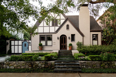 Example of a classic beige two-story mixed siding gable roof design in Houston