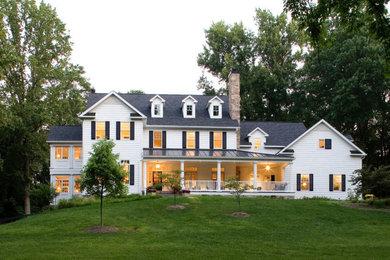 Large farmhouse white three-story house exterior idea in Baltimore