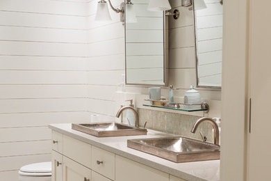 Design ideas for a mid-sized beach style 3/4 bathroom in Other with shaker cabinets, white cabinets, a two-piece toilet, mosaic tile, white walls, marble floors, a vessel sink, engineered quartz benchtops and white floor.