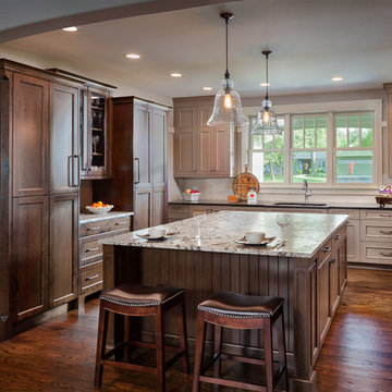 Cook's kitchen with large island and fully-paneled freezer and refrigerator