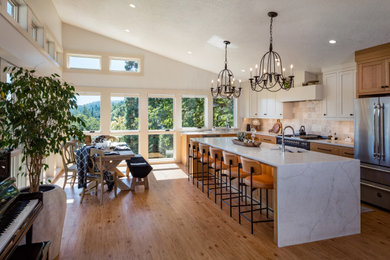 Eat-in kitchen - mid-sized contemporary medium tone wood floor eat-in kitchen idea in Other with shaker cabinets, light wood cabinets, quartzite countertops, black appliances and an island
