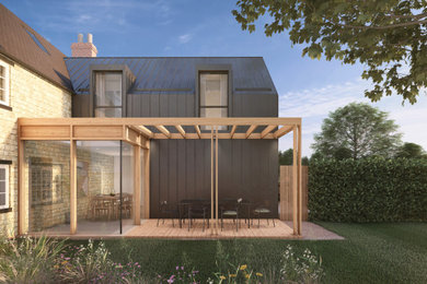 Inspiration for a medium sized and black contemporary two floor rear house exterior in Buckinghamshire with metal cladding, a pitched roof, a metal roof and a black roof.