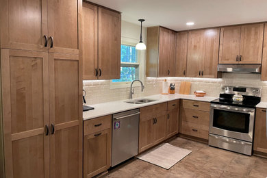 Eat-in kitchen - mid-sized modern u-shaped vinyl floor eat-in kitchen idea in Other with medium tone wood cabinets, quartz countertops, subway tile backsplash and white countertops