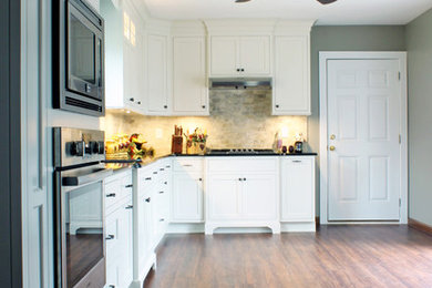 Mid-sized transitional l-shaped vinyl floor and brown floor eat-in kitchen photo in Other with an undermount sink, recessed-panel cabinets, white cabinets, quartz countertops, beige backsplash, ceramic backsplash, stainless steel appliances and no island