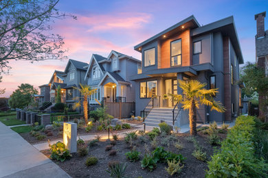 Mid-sized minimalist gray two-story mixed siding exterior home photo in Vancouver with a mixed material roof